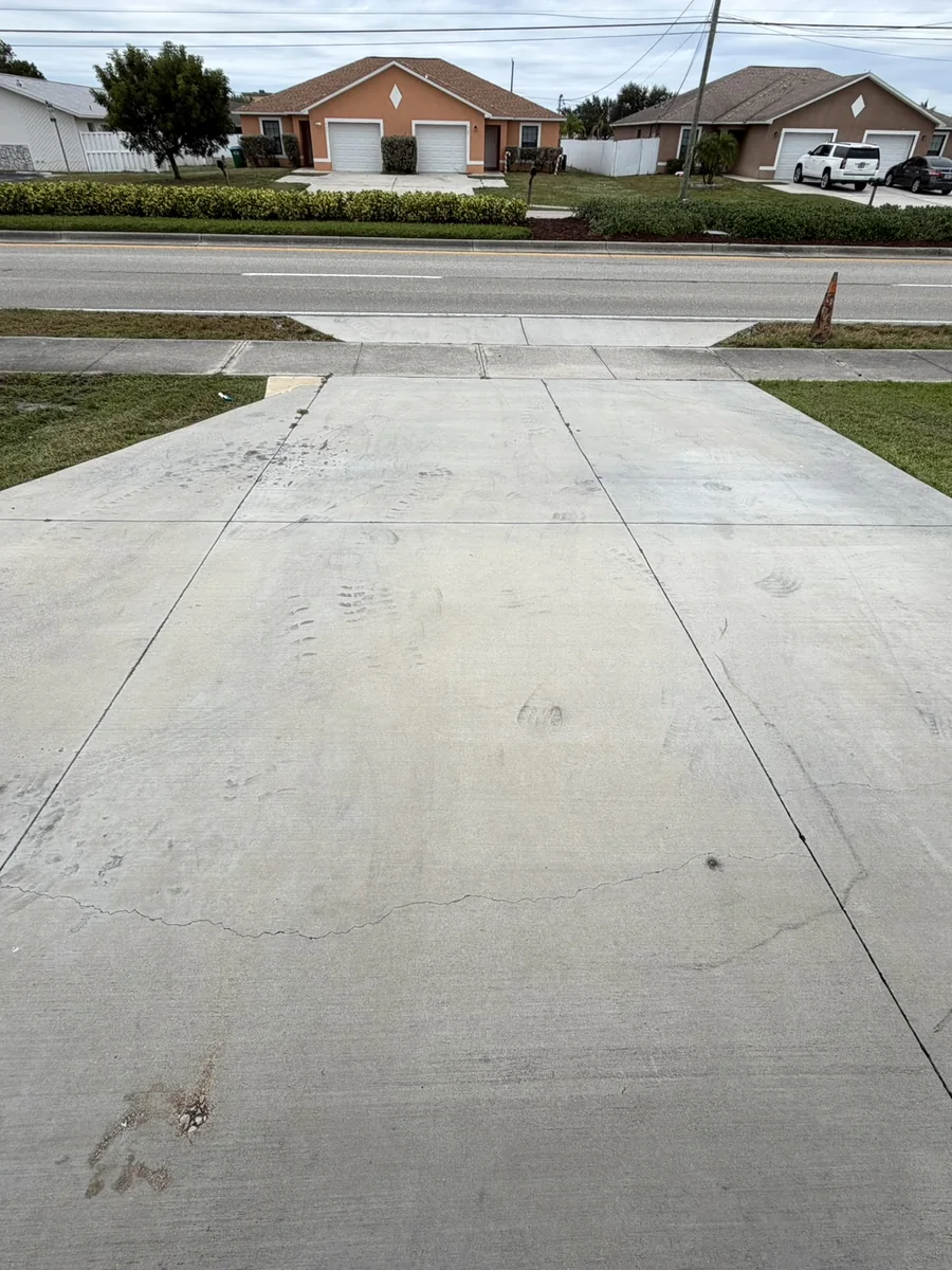 Driveway concrete brightened after pressure washing