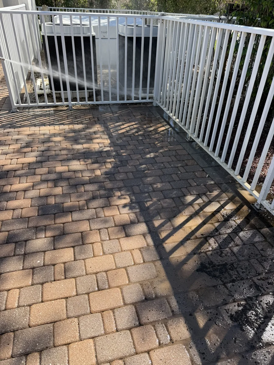 Community pool deck pavers with buildup before pressure washing